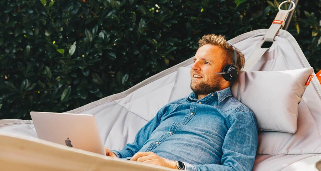 Voys colleague using his business phone system to work from a hammock